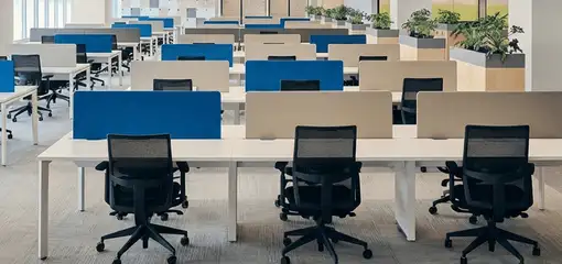 Modern open-plan office space featuring clean workstations, ergonomic chairs, and sanitized carpets provided by professional office cleaning services in Rockford, IL.
