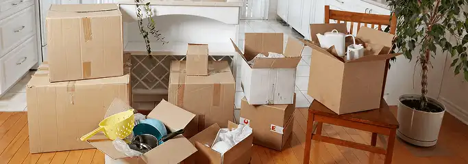 Packed moving boxes and household items in a kitchen before move-out or move-in cleaning, Rockford, IL.